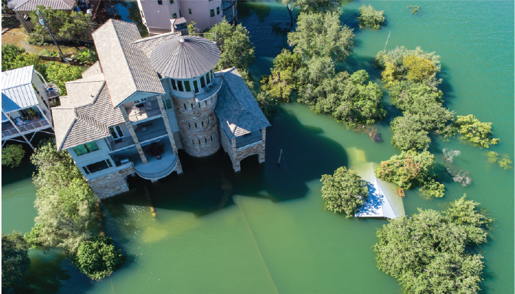 Large house surrounded by flooding